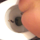 An attractive brunette girl is video-recorded taking a shit from behind the toilet with poop action visible and then seen from a frontal perspective showing her face while smoking and then wiping her ass. Over 6 minutes.